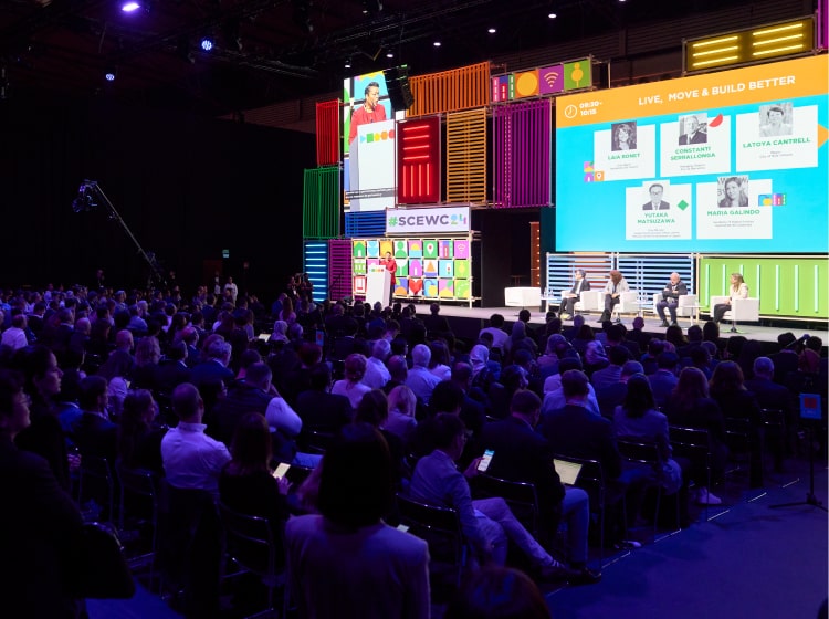 A large audience watching a talk at the SCEWC Congress.
