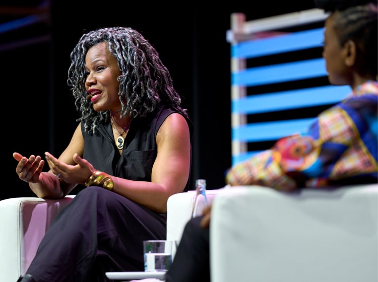 A woman talking on stage at the SCEWC Congress.